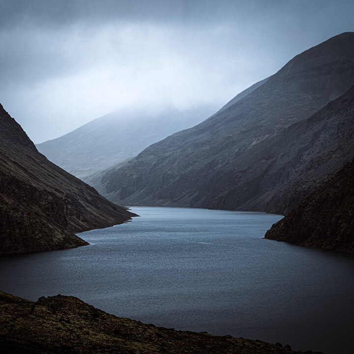 Image of Moody Mountain Valley with River and Low Clouds